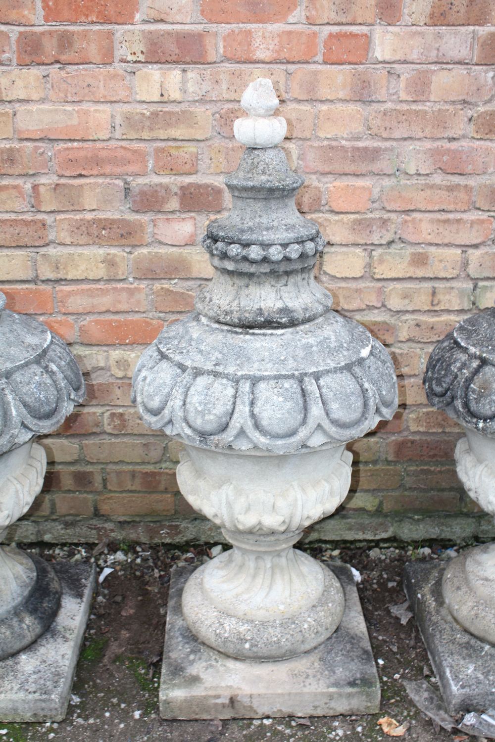A PAIR OF LARGE STONE PEDESTAL URNS, supported on a squared foot leading to a solid swirling base, - Image 3 of 3