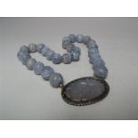 A LAVENDER JADE CARVED PANEL AND BEAD NECKLACE, the individual beads approx Dia. 1.5 cm with