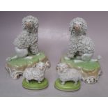 A PAIR OF DRESDEN CERAMIC DOG FIGURES, together with a smaller pair of Dresden sheep figures,