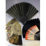 THREE VINTAGE EBONISED FOLDING FANS, together with a lucite example depicting matadors and bull