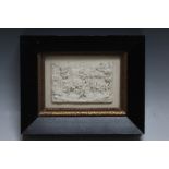 A FRAMED CARVED PLAQUE OF REVELLERS DRINKING OUTSIDE A TAVERN, W 18 cm