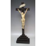 A EUROPEAN CARVED IVORY CORPUS CHRISTI ON AND EBONY CROSS, bearing ivory 'INRI' plaque to the top, H