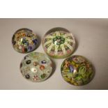 FOUR ASSORTED GLASS PAPERWEIGHTS TO INCLUDE MILLEFIORI CANE EXAMPLES, largest Dia 7 cm