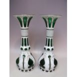 A PAIR OF BOHEMIAN GREEN GLASS AND WHITE ENAMEL OVERLAY VASES, with gilt decoration, H 32 cm