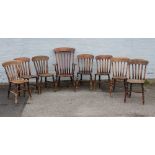 A HARLEQUIN SET OF EIGHT ANTIQUE TRADITIONAL WINDSOR KITCHEN CHAIRS TO INCLUDE AN ARMCHAIR, each