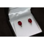 A PAIR OF 18ct WHITE GOLD RUBY AND DIAMOND STUDS, boxed. Rubies 4.00ct. Diamonds 0.06ct