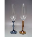 A BOXED SET OF KOSTA BODA CHAMPAGNE GLASSES 'TWO OF US' DESIGNED BY KJELL ENGMAN, together with a