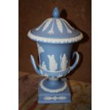 A WEDGWOOD BLUE JASPERWARE TWIN HANDLED CAMPANA LIDDED URN