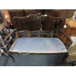 AN EDWARDIAN EBONISED TWO SEATER SOFA