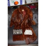 A LADIES VINTAGE FUR COAT TOGETHER WITH A VINTAGE PURSE PLUS ANOTHER