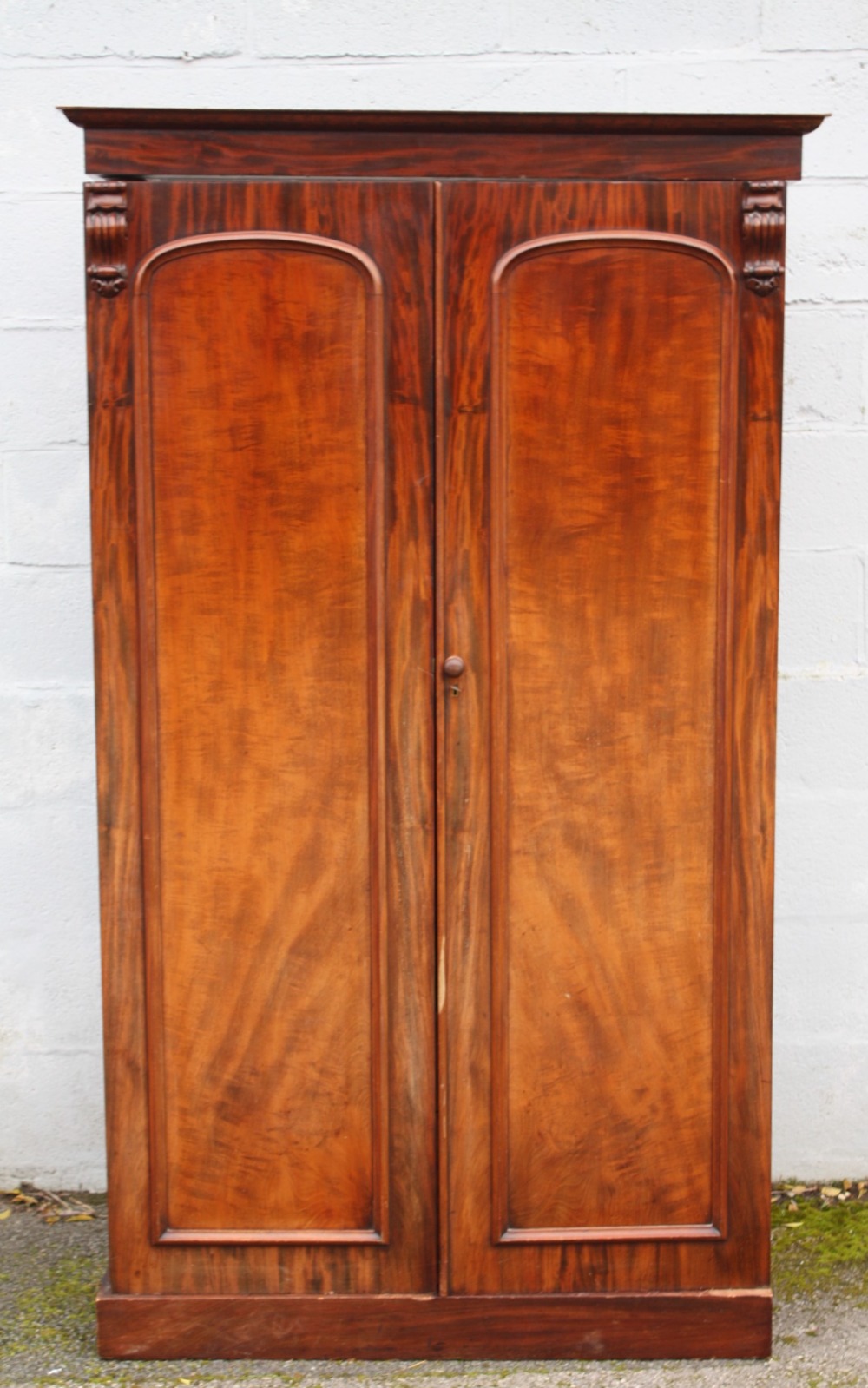 A 19TH CENTURY TWIN DOOR WARDROBE OF SMALL PROPORTIONS, the twin doors opening ti a hanging rail and