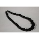 A CARVED WHITBY JET BEADED NECKLACE