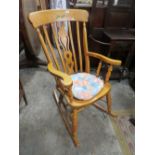 A MODERN LIGHT COLOURED ROCKING CHAIR