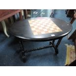 AN EDWARDIAN EBONISED GAMES TABLE