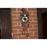 A REPRODUCTION MAHOGANY WALL CLOCK WITH WEIGHTS