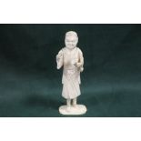 A JAPANESE CARVED IVORY OKIMONO, depicting an artist / scholar, the right hand with a missing