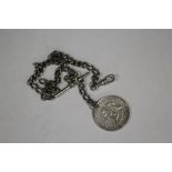 AN ANTIQUE SILVER ALBERT CHAIN WITH HALF DOLLAR COIN FOB