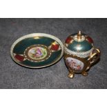 A CONTINENTAL STYLE FIGURATIVE CUP AND SAUCER WITH COVER
