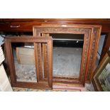 A PAIR OF CARVED OAK PICTURE FRAMES TOGETHER WITH A PAIR OF SMALL OAK PICTURE FRAMES