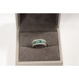 A WHITE GOLD EMERALD AND DIAMOND RING, set with an estimated 1.20 carats of emeralds and twenty