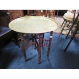 AN EASTERN BRASS TOPPED FOLDING TABLE