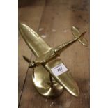 A BRASS MODEL OF A PLANE IN FLIGHT