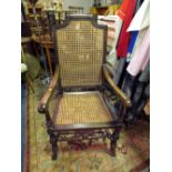 A LARGE OAK FRAMED BERGERE ARMCHAIR