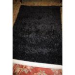 A MODERN INDIAN BLACK RUG 120 X 180 CM