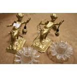 A PAIR OF GILDED CAST METAL CHERUBIC WALL LIGHTS WITH GLASS SHADES