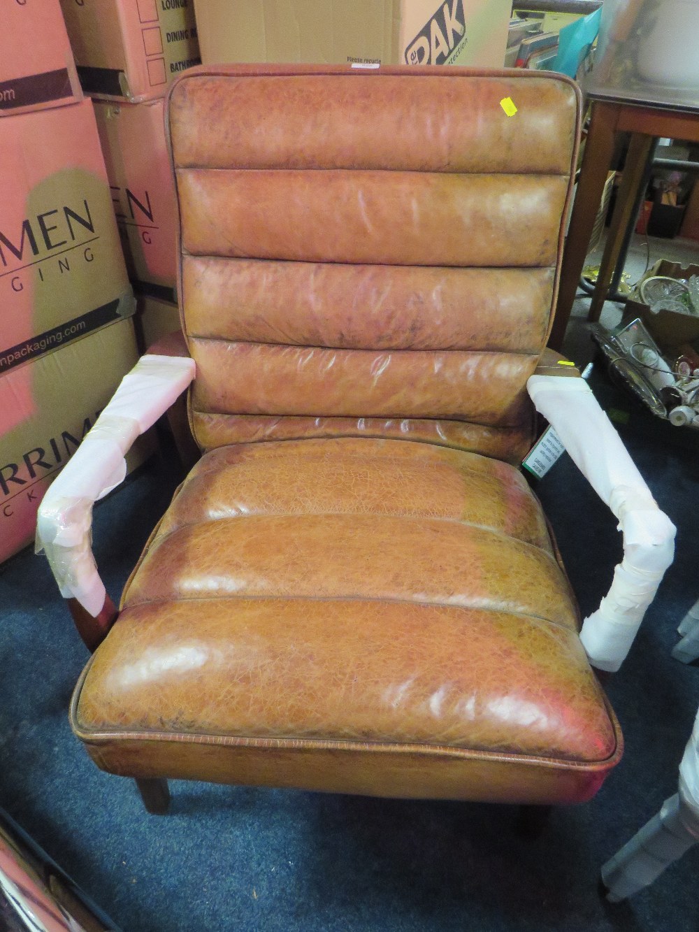 A MODERN TAN LEATHER ARMCHAIR S/D