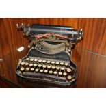 AN ANTIQUE CORONA FOLDING TYPEWRITER