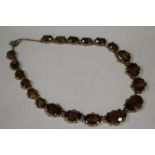 A VINTAGE TIGERS EYE STYLE AGATE NECKLACE, in a gilt mount