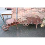 TWO VINTAGE WOODEN WHEELBARROWS