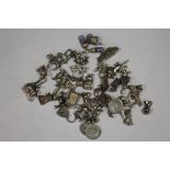 A LARGE QUANTITY OF SILVER BRACELET CHARMS APPROX WEIGHT 100G