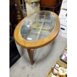 A RETRO TEAK OVAL GLASS TOPED COFFEE TABLE H-41 CM W-129 CM