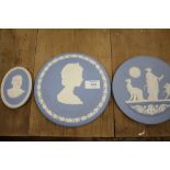 TWO LARGE WEDGWOOD JASPERWARE CIRCULAR PLAQUES, TOGETHER WITH A SMALLER OVAL SHAPED EXAMPLE (3)