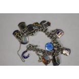 A SILVER CHARM BRACELET WITH ENAMELLED CHARMS