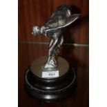 A VINTAGE CHROMED STATUETTE / CAR MASCOT OF 'THE SPIRIT OF ECSTASY', raised on a circular base,