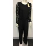 MICHAEL KORS - a ladies black jumpsuit with lace sleeves, size 8