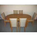 A SKOVBY EXTENDING OVAL DINING TABLE AND SIX CHAIRS