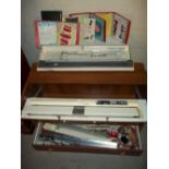 A BROTHER KNITTING MACHINE AND ACCESSORIES WITH AN ENCLOSED UNIT AND VARIOUS KNITTING PATTERNS