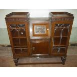 AN OAK ANTIQUE BUREAU DISPLAY CABINET WITH LEATHER INLAY
