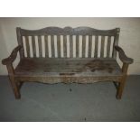 A HEAVY WOODEN GARDEN BENCH