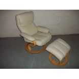 A FAUX LEATHER SWIVEL RECLINER CHAIR AND FOOT STOOL