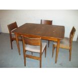 A VINTAGE TEAK EXTENDING DINING TABLE WITH FOUR CHAIRS