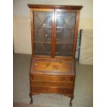 AN ANTIQUE LEATHER INLAID BUREAU BOOKCASE WITH BALL & CLAW FEET