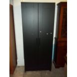 AN IKEA TWO DOOR WARDROBE IN BLACK