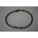 A 9 CT GOLD AQUAMARINE AND DIAMOND CHIP BRACELET, approx. length 20 cm