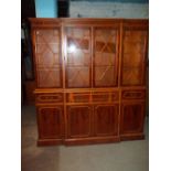 A BREAKFRONT WALL DISPLAY UNIT WITH LEATHER INLAID PULL OUT WRITING DESK