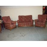 AN OAK ERCOL THREE PIECE SUITE, CONSISTING OF A TWO SEATER SOFA AND TWO CHAIRS